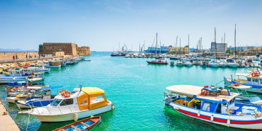 Boats moored in Heraklion old venetian port harbour in Crete.
